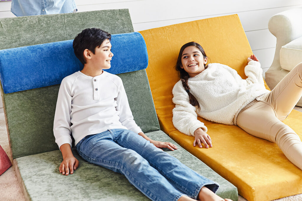 Photo shows two children laying on the Brentwood Home eco couch.
