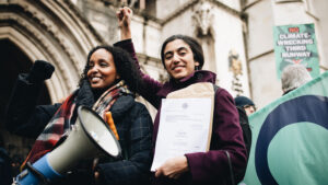 Photo shows Friends of the Earth lawyer Katie de Kauwe (R) celebrating with her fellow campaigners in 2020 just after a court ruled against a third runway for Heathrow airport. Successful climate lawsuits are becoming more common.