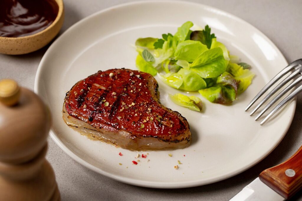 Photo shows a 3D-printed cultivated steak on a plate