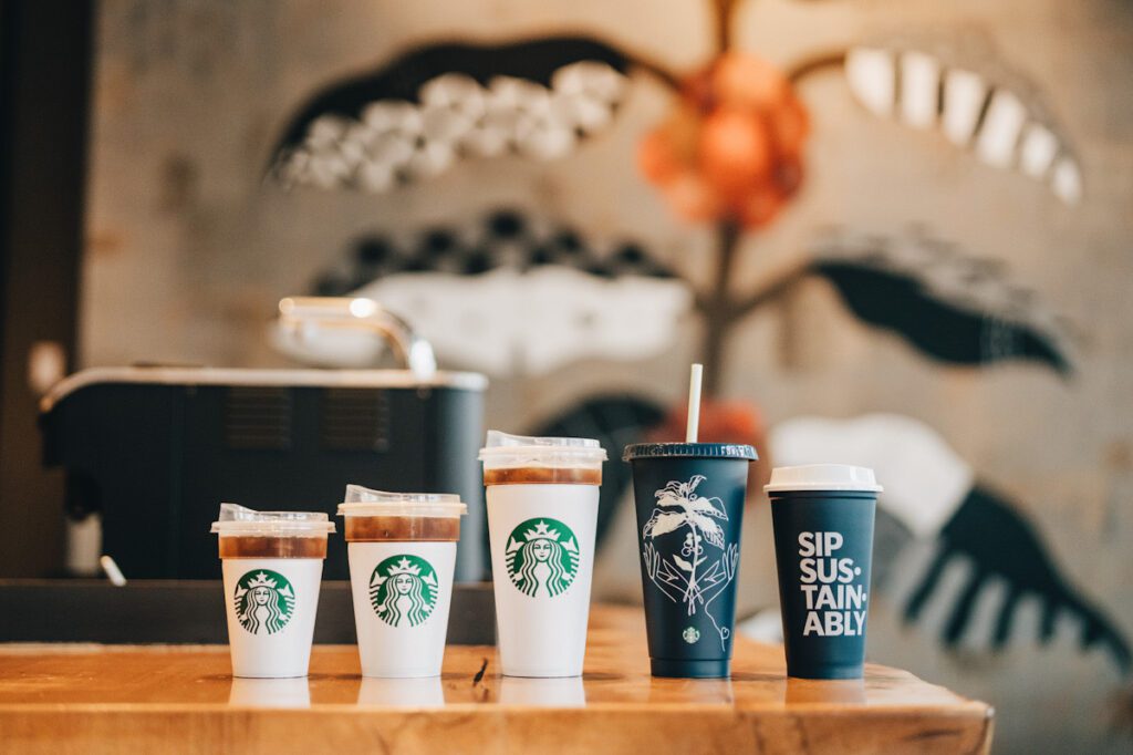 Photo shows a variety of Starbucks-branded reusable cups. Starbucks aims to phase out all single-use cups over the next few years.