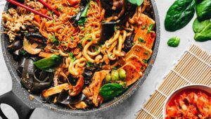 Photo shows a vegan hot pot made with lots of noodles and mushrooms